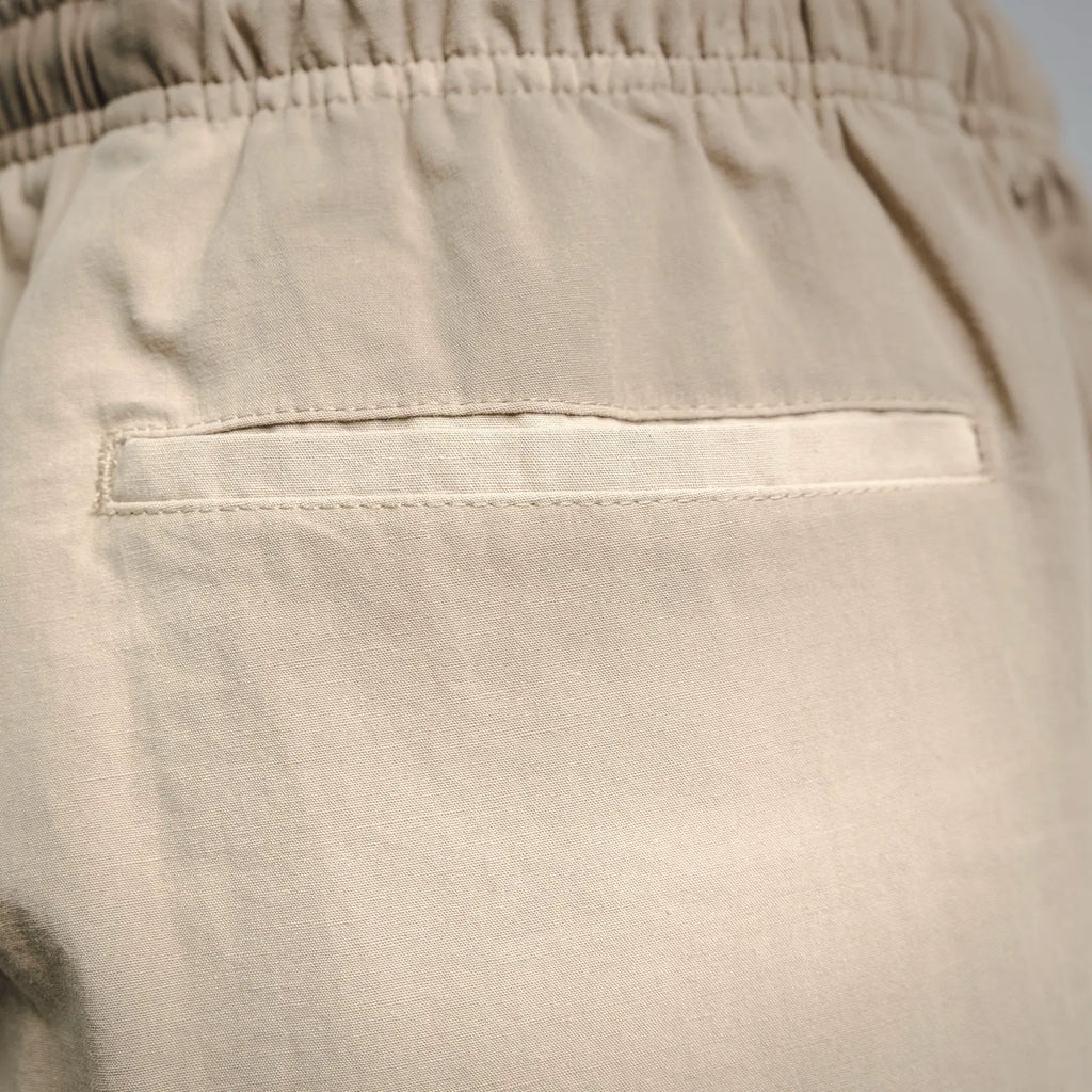 Beige pants front pocket with rectangular welt and top stitching