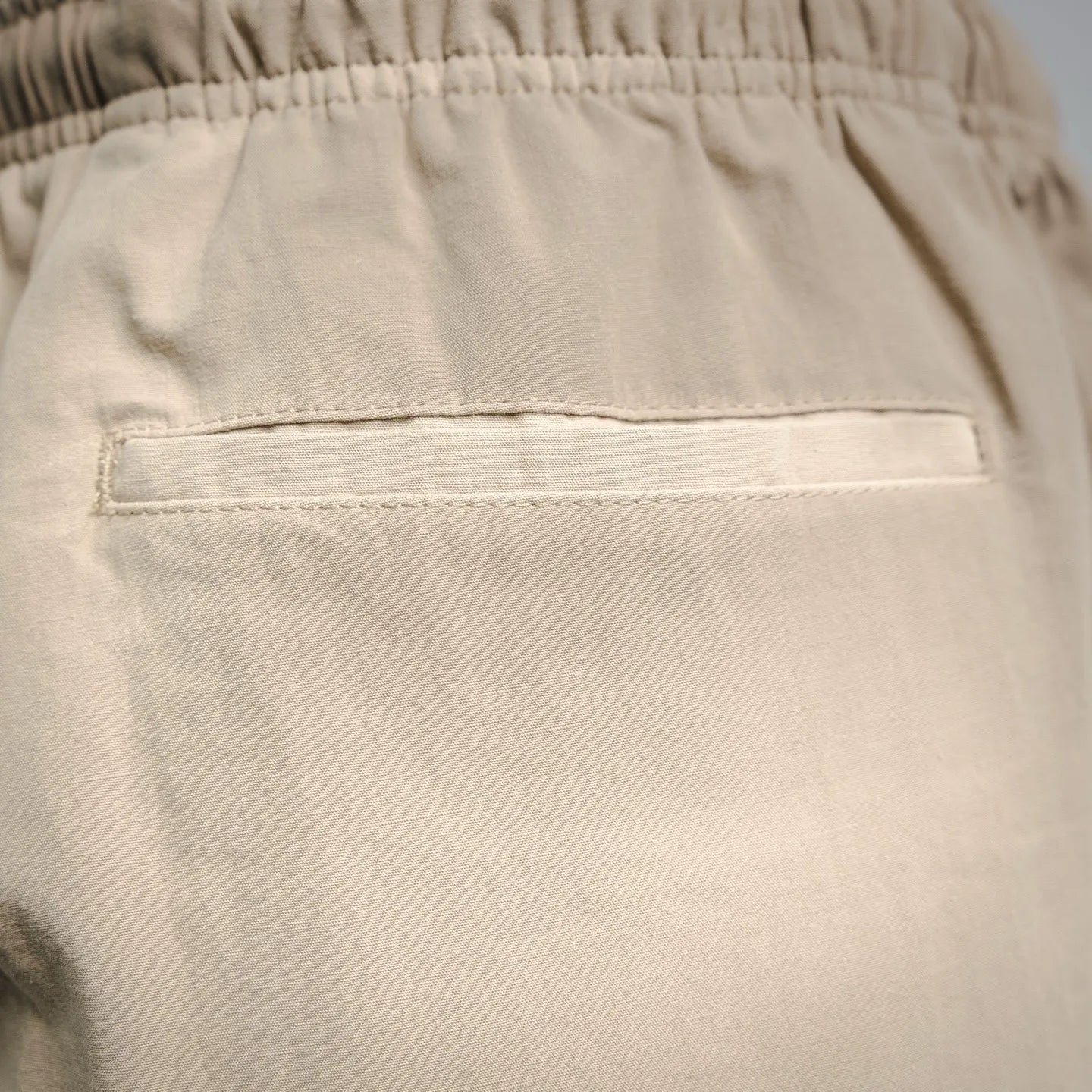 Beige pants front pocket with rectangular welt and top stitching