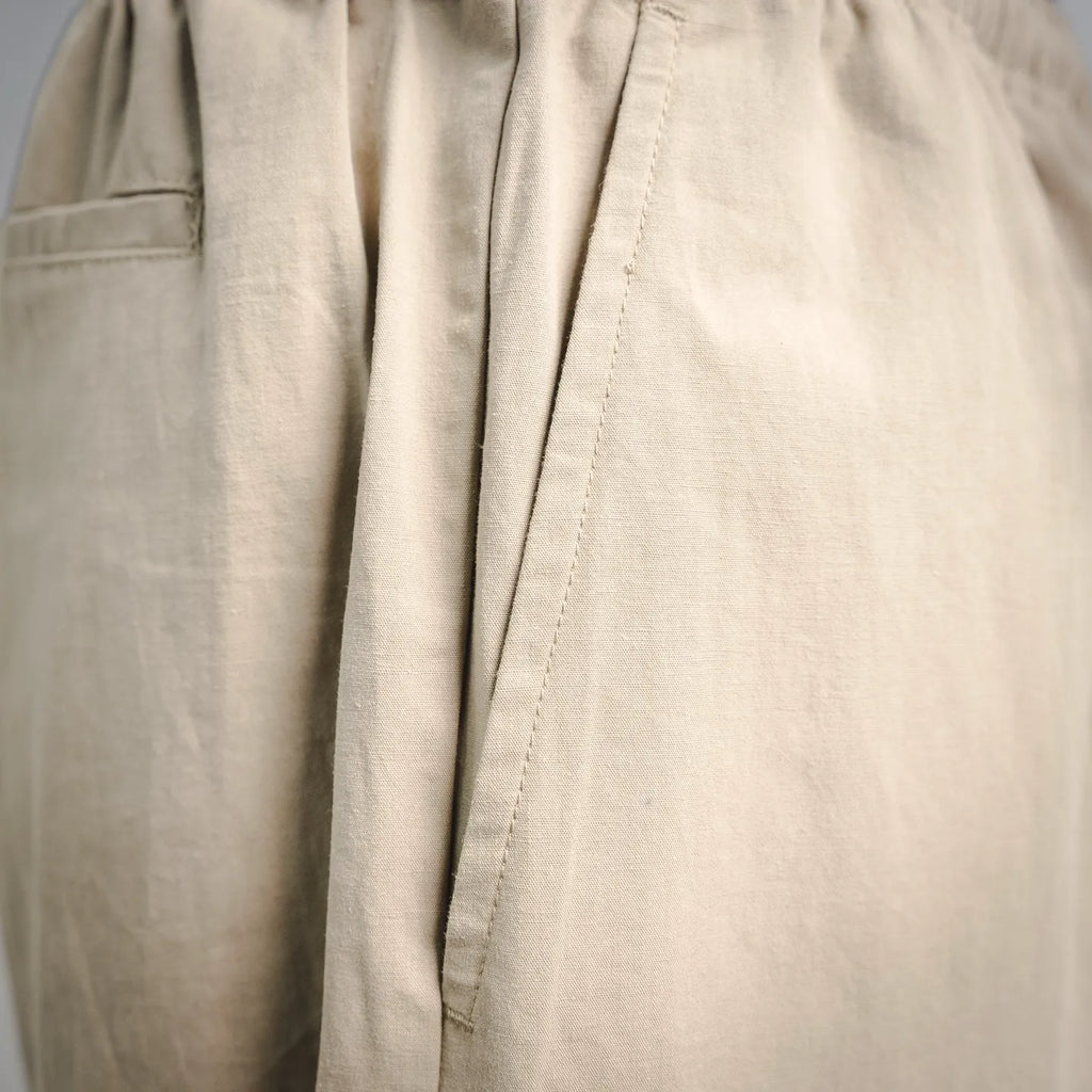 Beige pants with vertical seam and stitched front panel detail
