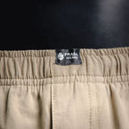 Beige pants with Prada Milano logo patch on elastic waistband