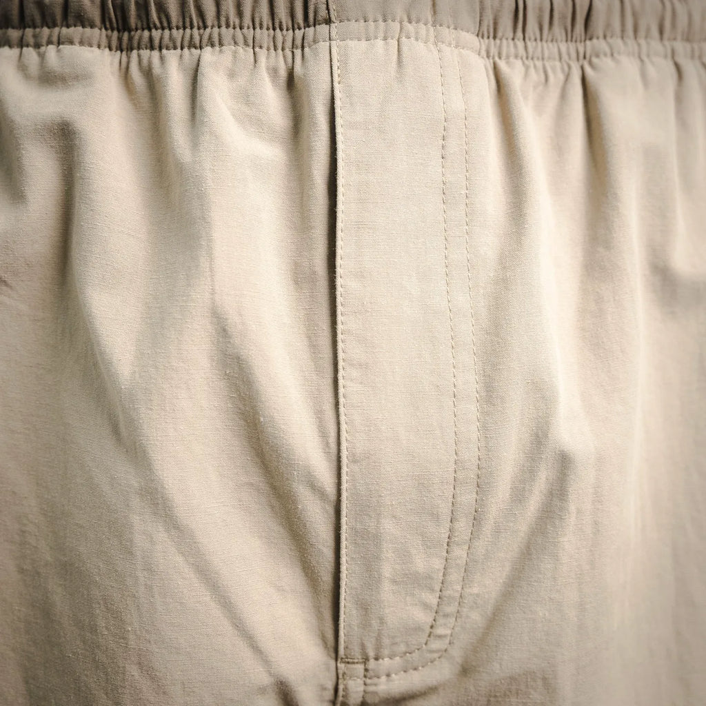 Beige pants inner fly seam and waistband stitching detail