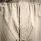 Beige pants inner fly seam and waistband stitching detail
