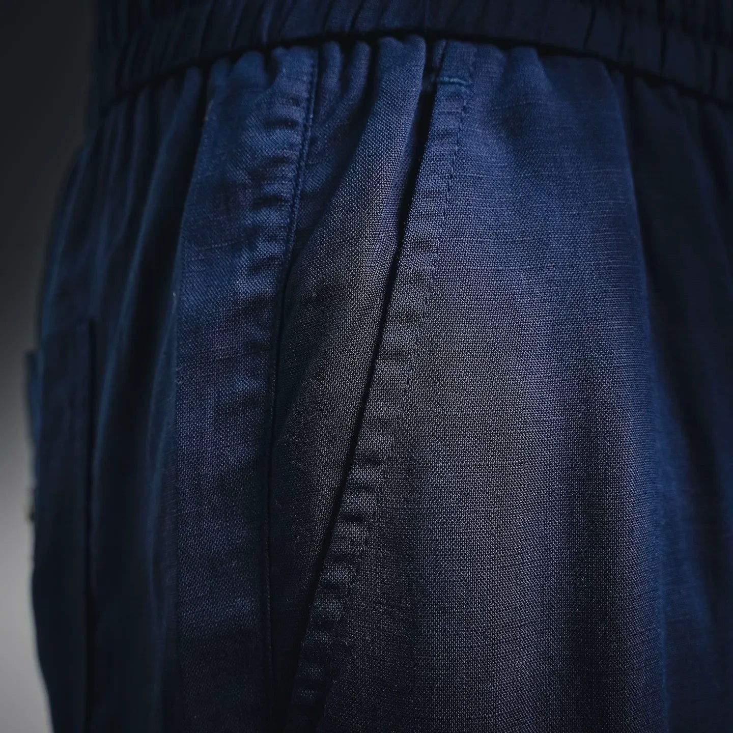 Prada pants waist and pleat detail, dark blue woven fabric with seam lines