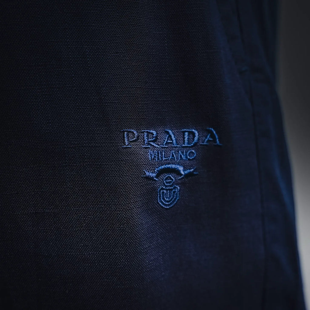 Prada pants small embroidered logo on dark blue fabric
