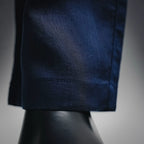 Prada pants lower leg and hem, dark blue woven texture and stitched seam