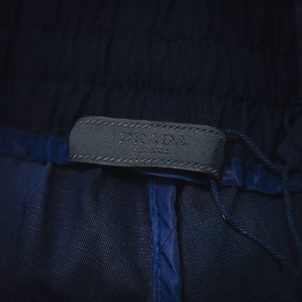 Prada pants inner waistband label with PRADA MILANO text on dark blue