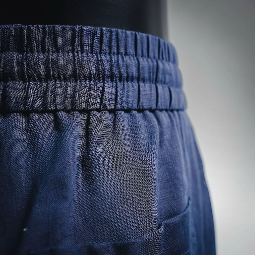 Prada pants waistband close-up with elastic gathers and front pocket opening