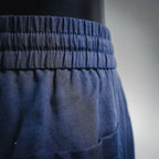 Prada pants waistband close-up with elastic gathers and front pocket opening