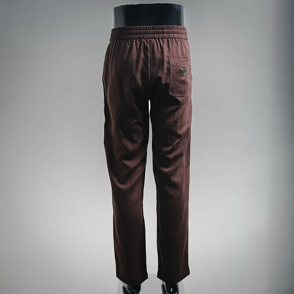 Prada pants in dark burgundy with elastic waistband, side pocket detail, tapered fit