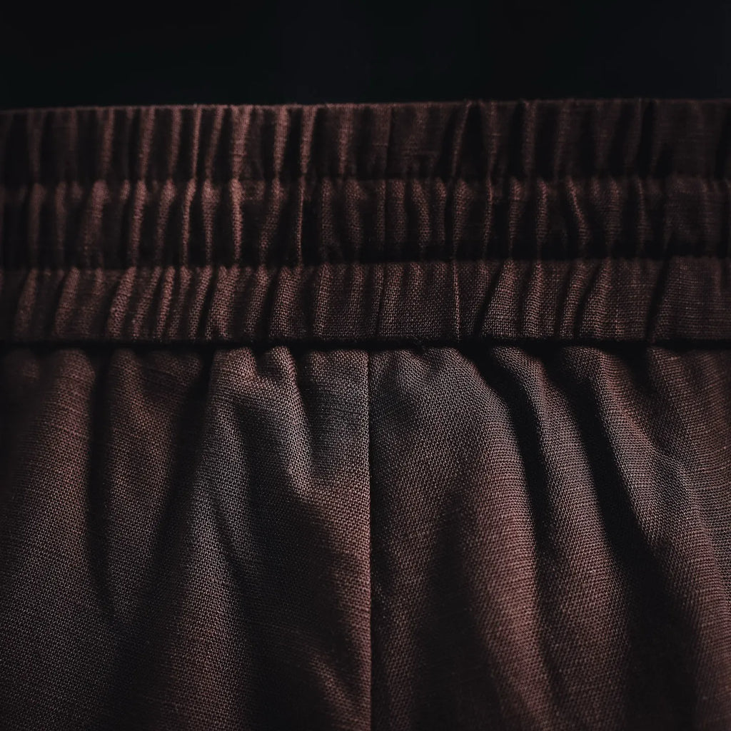 Prada pants fabric and pleats under elastic waistband in dark burgundy