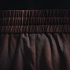 Prada pants fabric and pleats under elastic waistband in dark burgundy