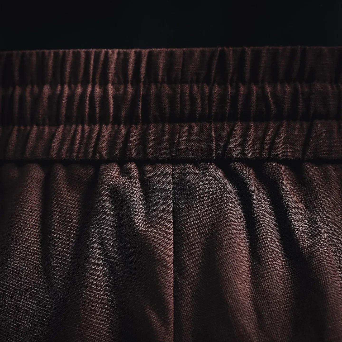 Prada pants fabric and pleats under elastic waistband in dark burgundy