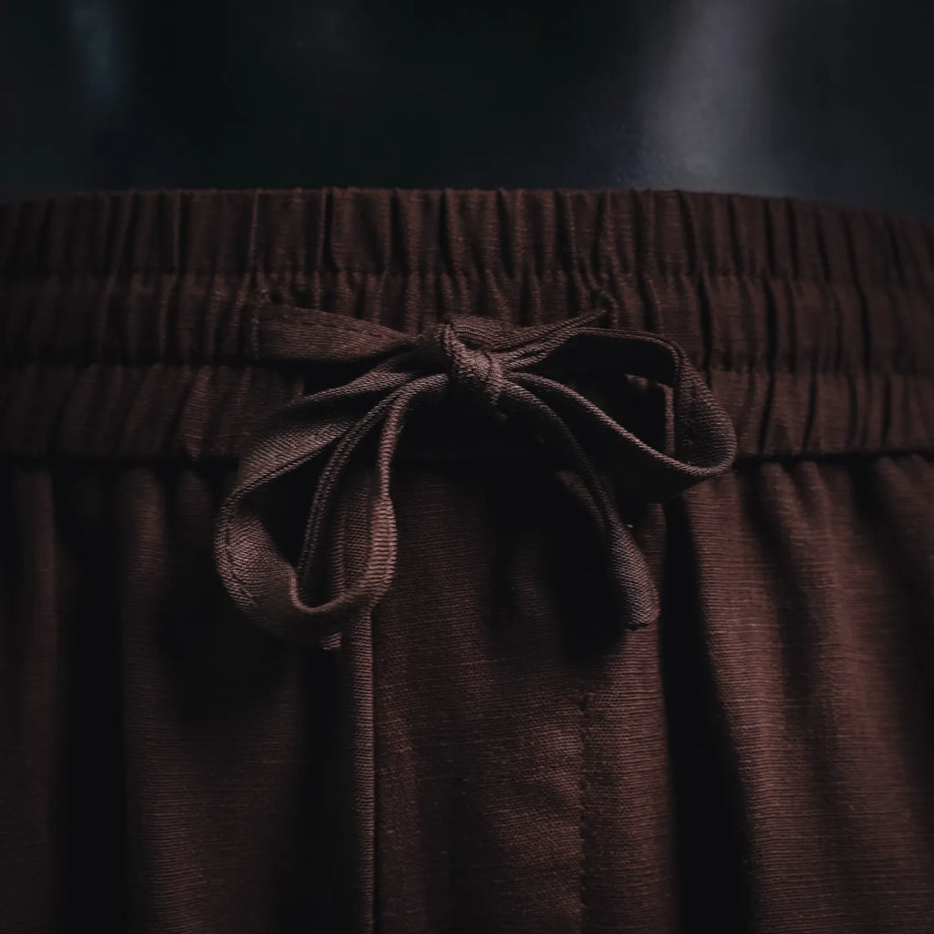 Prada pants drawstring tied at the elastic waistband in dark burgundy