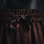 Prada pants drawstring tied at the elastic waistband in dark burgundy