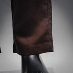 Prada pants hem and drape at the leg opening in dark burgundy