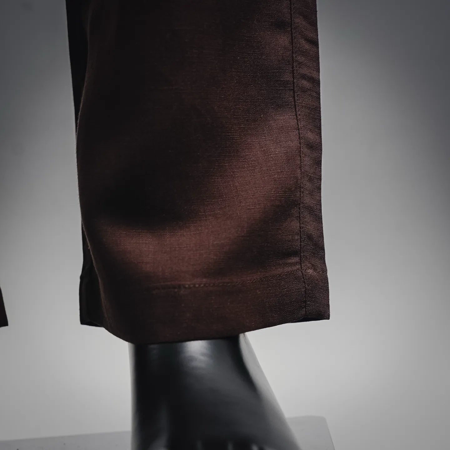 Prada pants hem and drape at the leg opening in dark burgundy