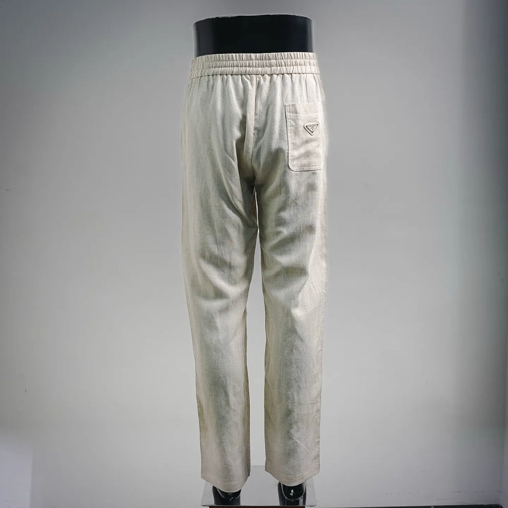 Light beige drawstring pants with elastic waist and back patch pocket