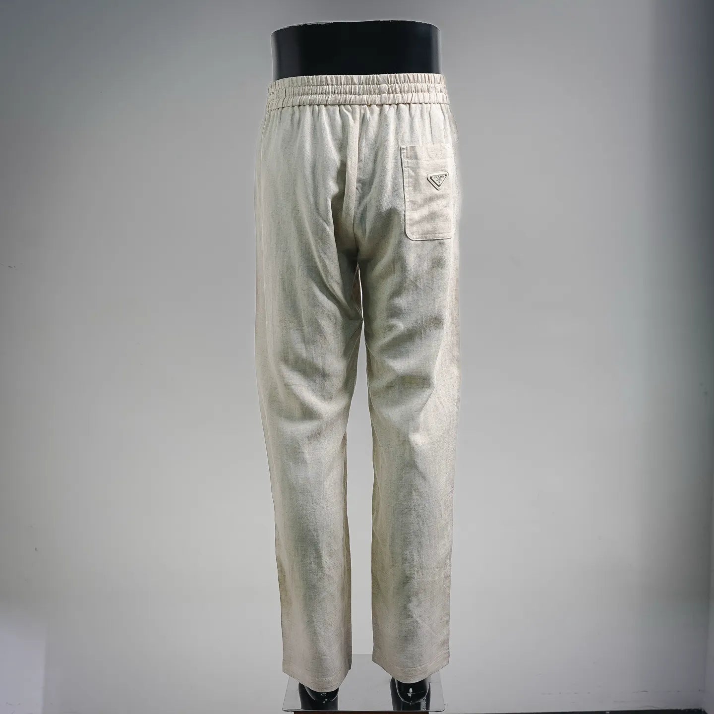 Light beige drawstring pants with elastic waist and back patch pocket