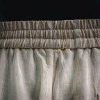 Light beige pants with elastic waistband and gathered seam detail