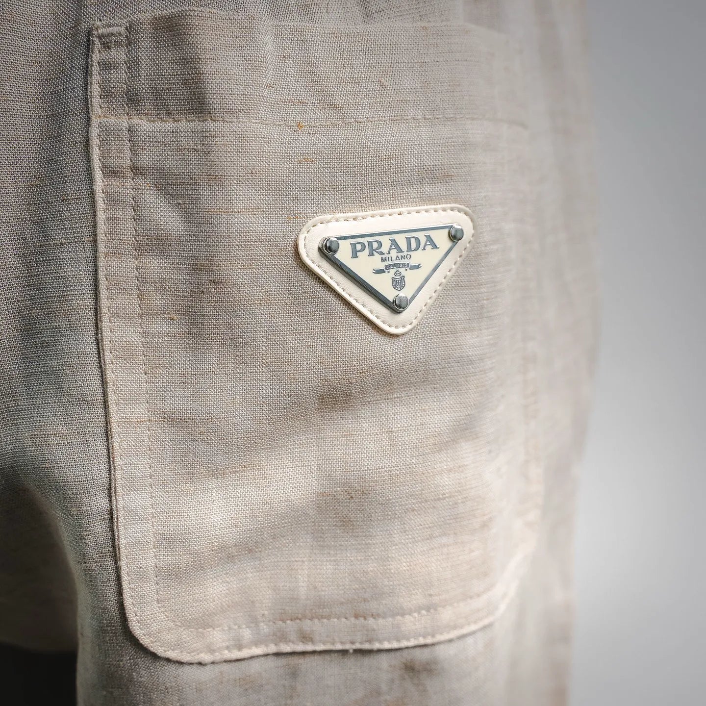 Light beige pants back patch pocket with Prada triangular logo patch