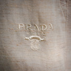 Light beige pants with embroidered PRADA MILANO logo on front