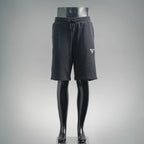 Dark gray Prada track pants with drawstring waist and logo patch on right thigh