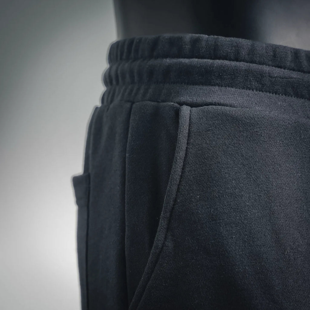 Dark gray elastic waistband with pleated front and side seam on shorts