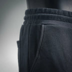 Dark gray elastic waistband with pleated front and side seam on shorts
