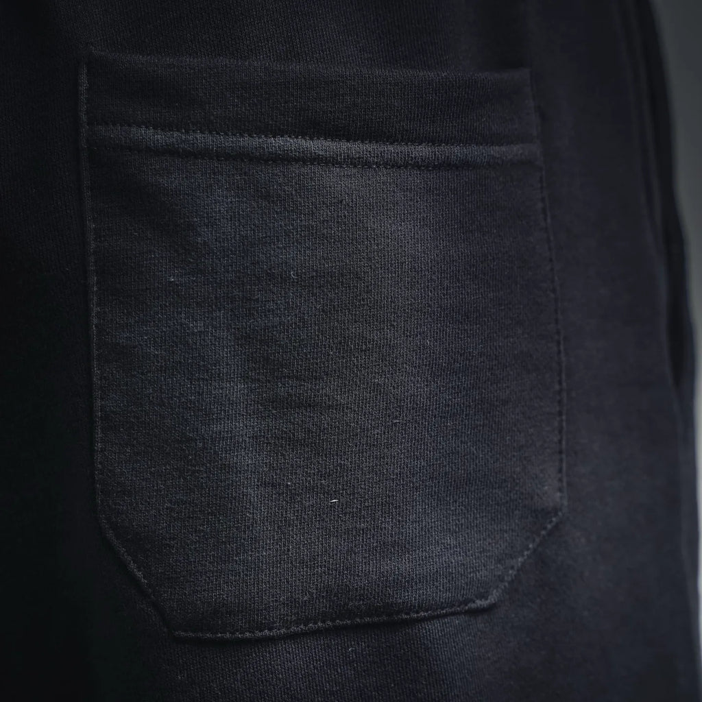 Dark gray front pocket with stitched seam on track shorts