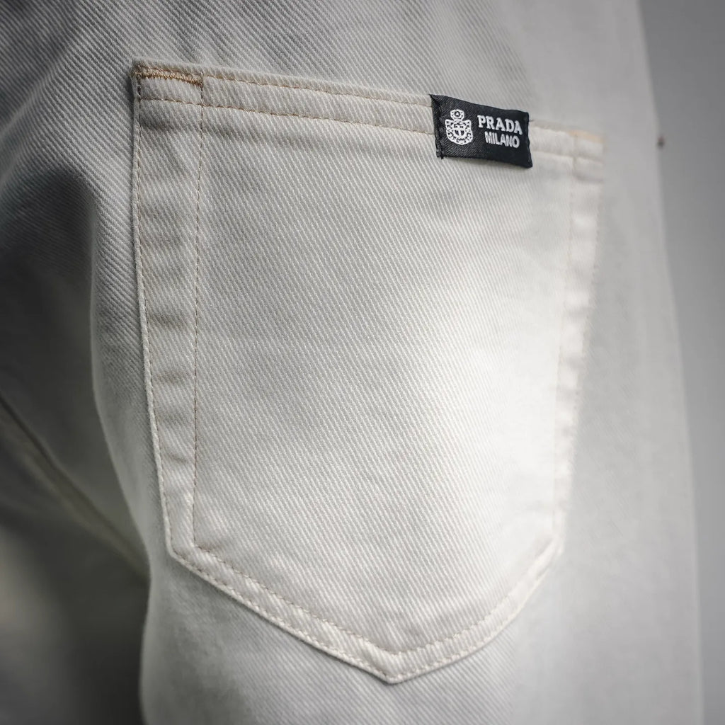 White Prada pants pocket with inner brand label on the lining.