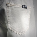 White Prada pants pocket with inner brand label on the lining.