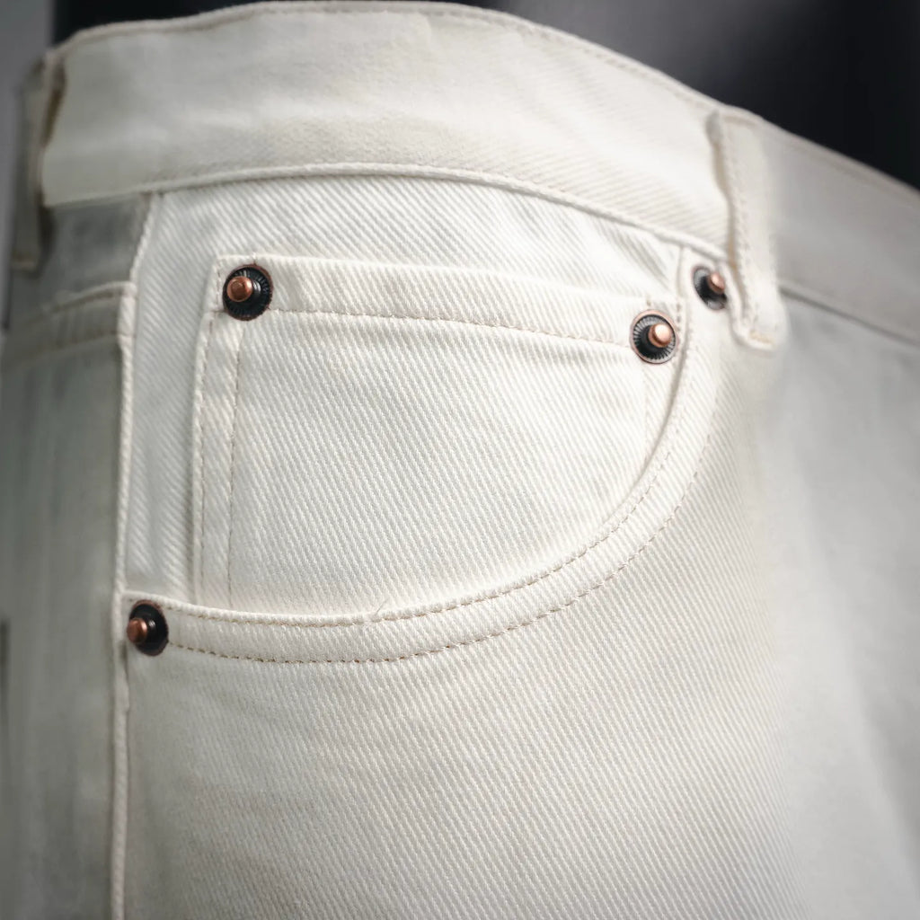 White Prada pants front pocket with dark buttons and rivets.