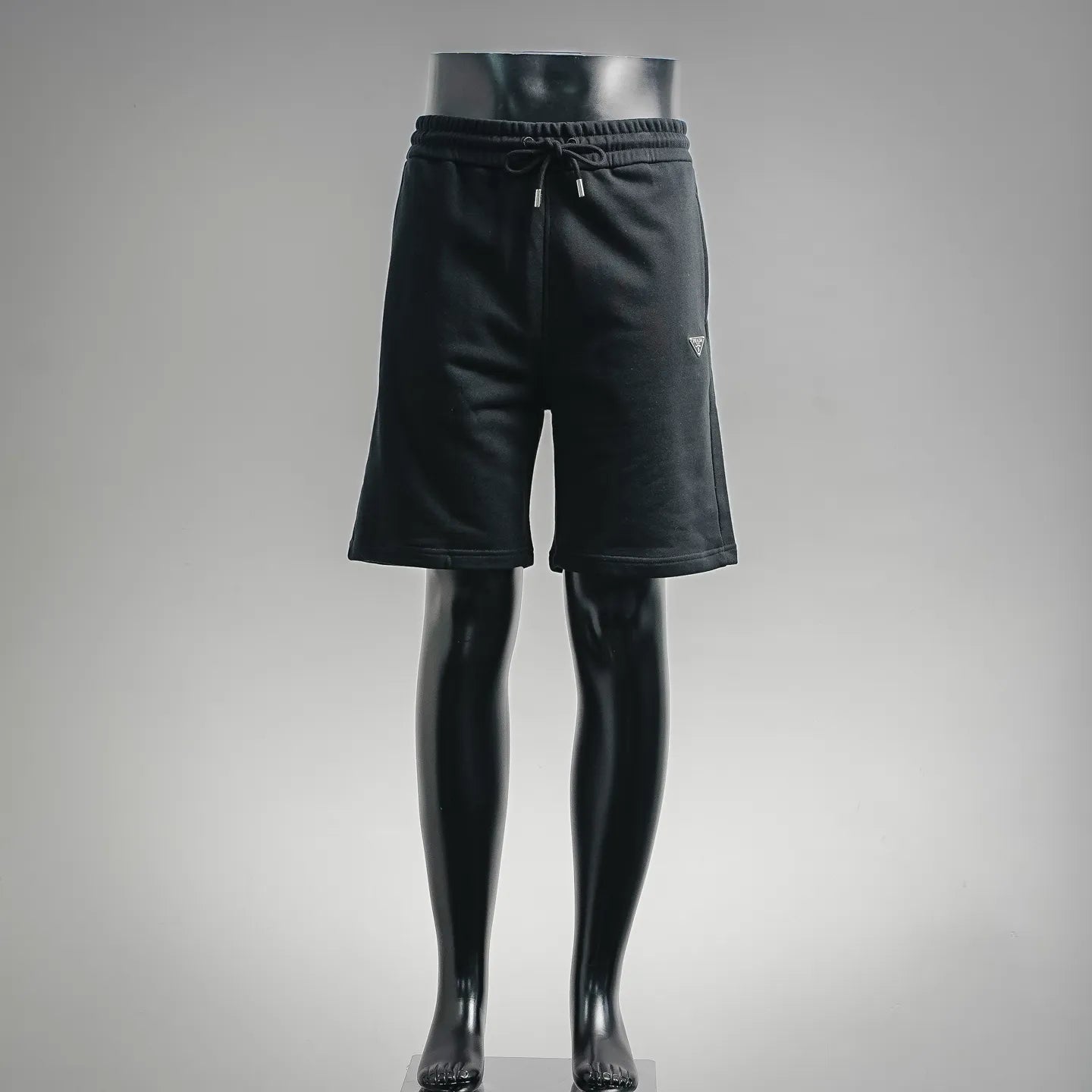 Black knee-length drawstring shorts with elastic waistband