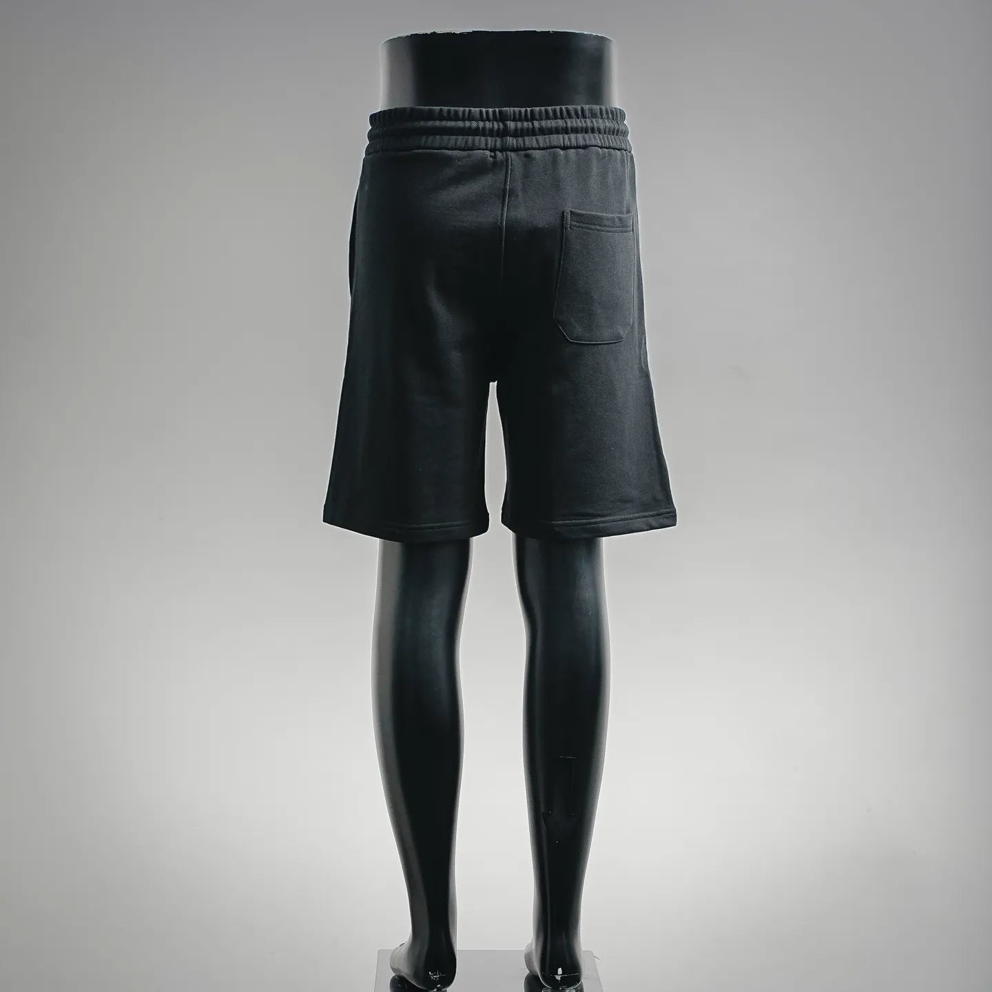Black knee-length drawstring shorts with back pocket