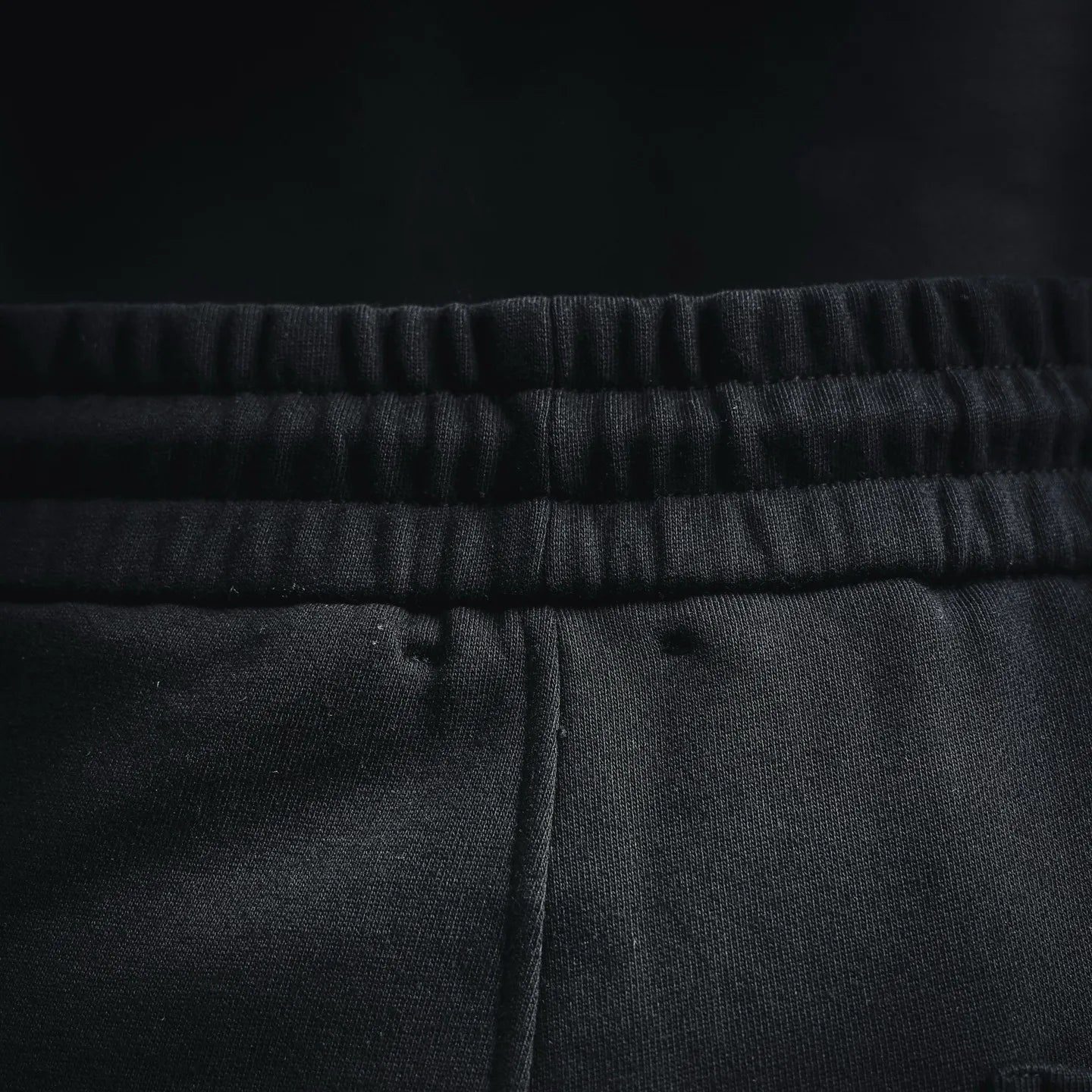 Elastic waistband with textured knit look on black shorts