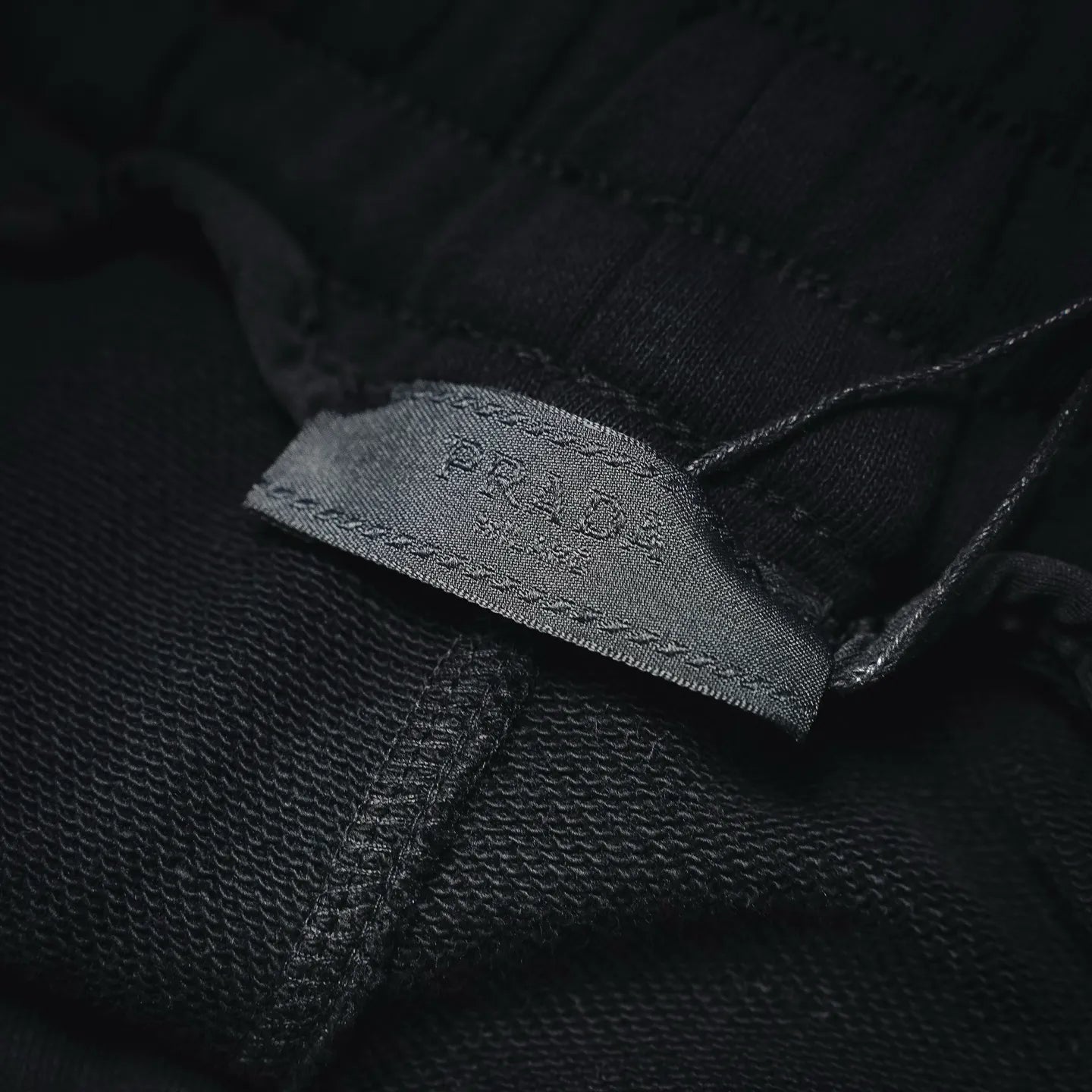 Inside label stitched on black shorts fabric