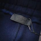 Prada blue shorts fabric label near waistband with stitched drawstring
