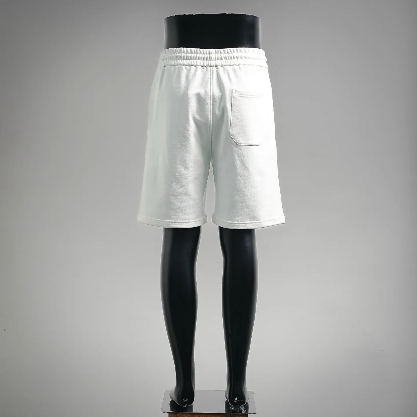 White drawstring shorts with elastic waistband and side pocket