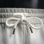 White drawstring with two cord aglets on elastic waistband