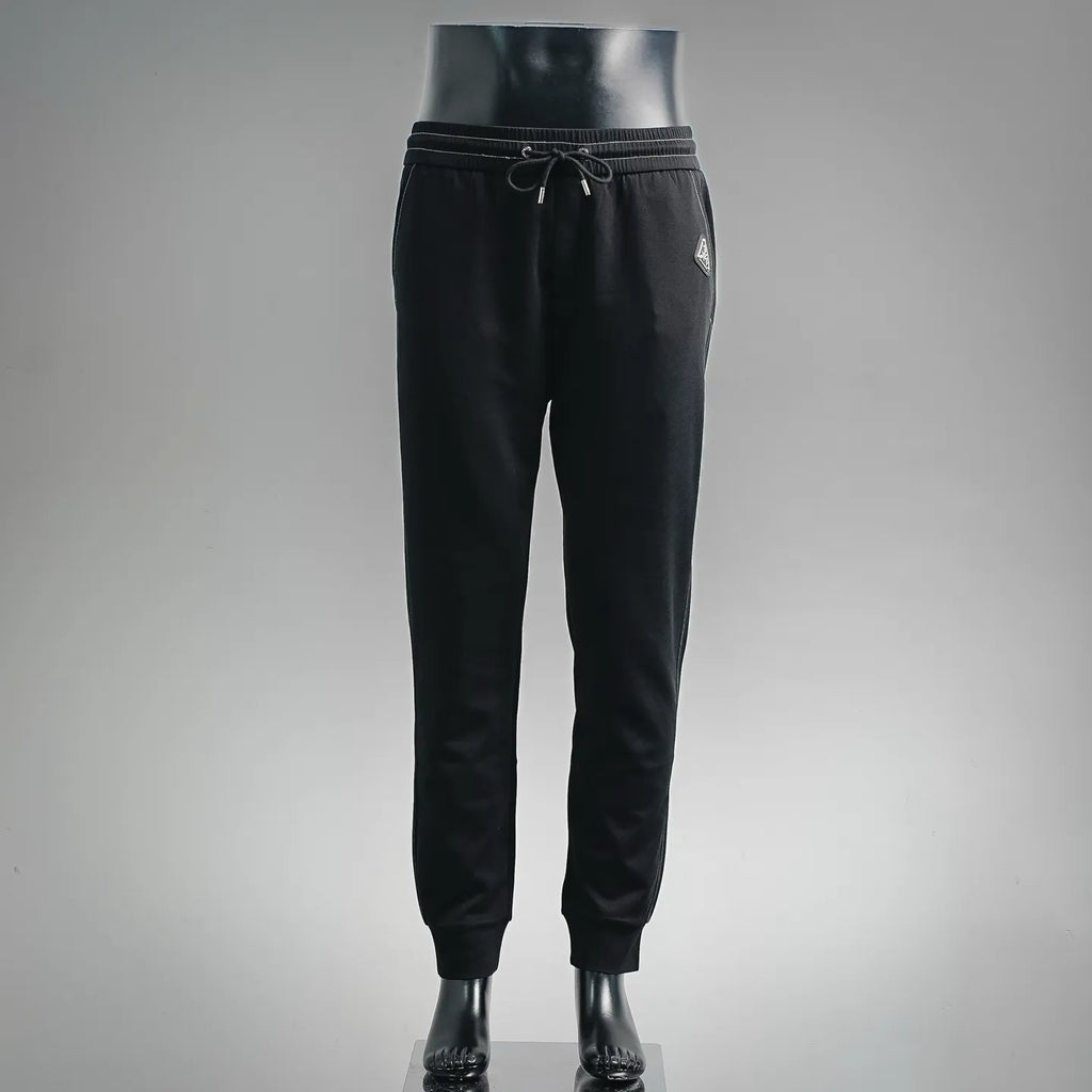 Prada black pants with elastic waistband, drawstring, and tapered jogger cuffs