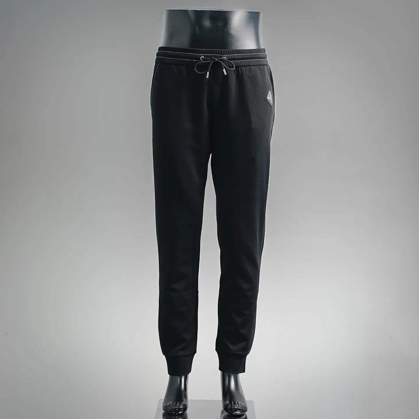 Prada black pants with elastic waistband, drawstring, and tapered jogger cuffs