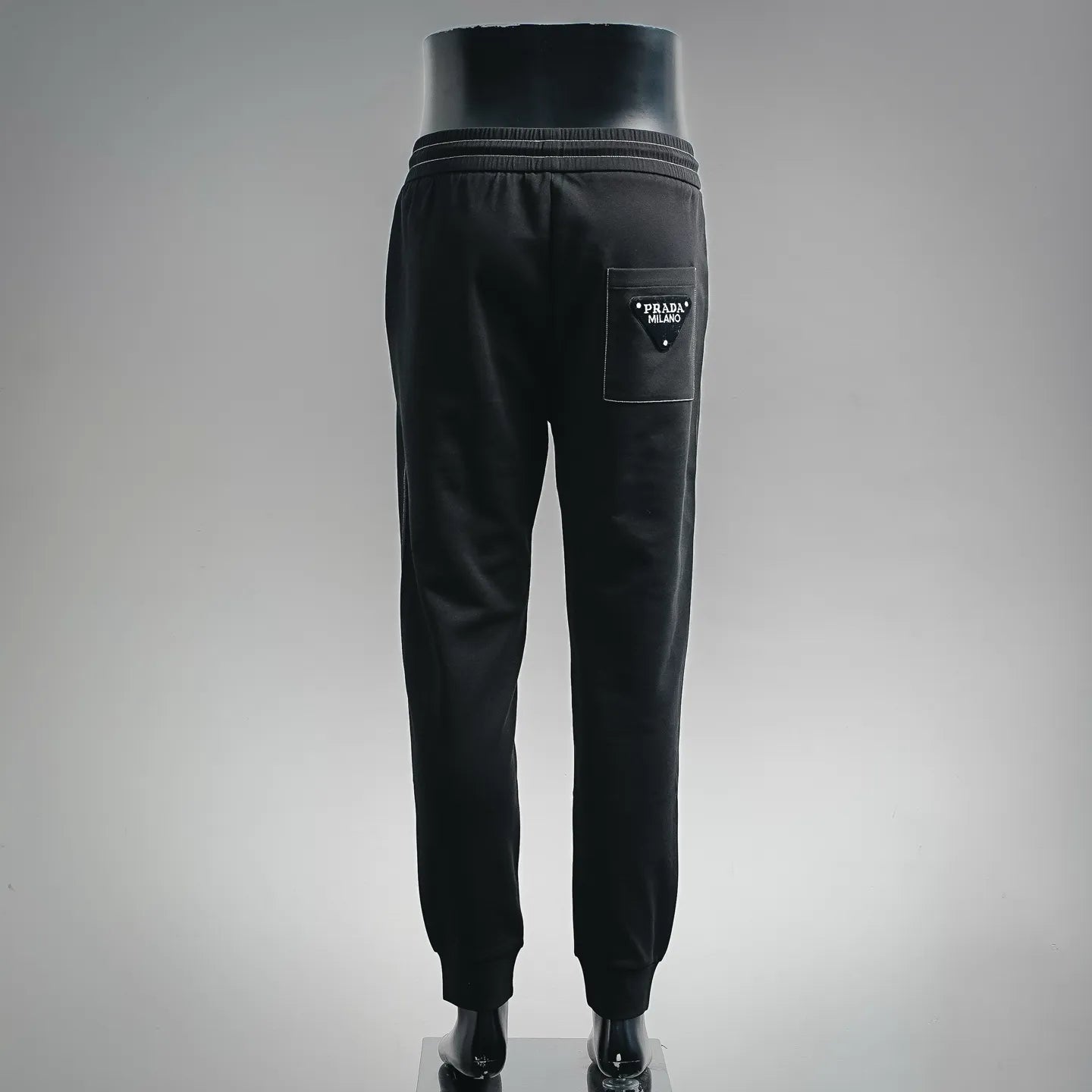 Prada black pants, back view with elastic waistband and back pocket logo patch
