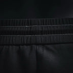 Prada black pants waistband close-up with stitched elastic detail