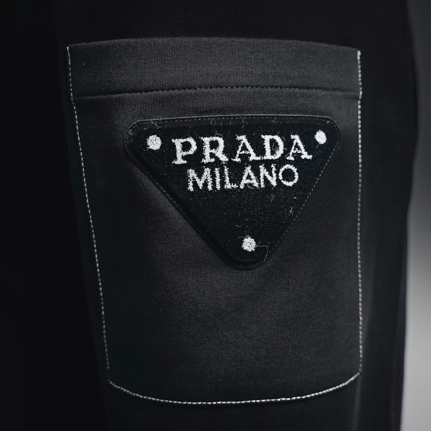 Prada black pants back pocket with PRADA MILANO logo patch