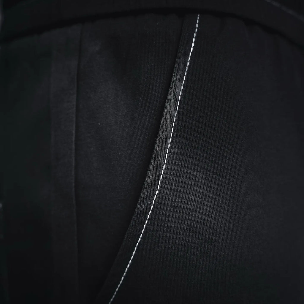 Prada black pants side seam close-up with contrasting stitch line