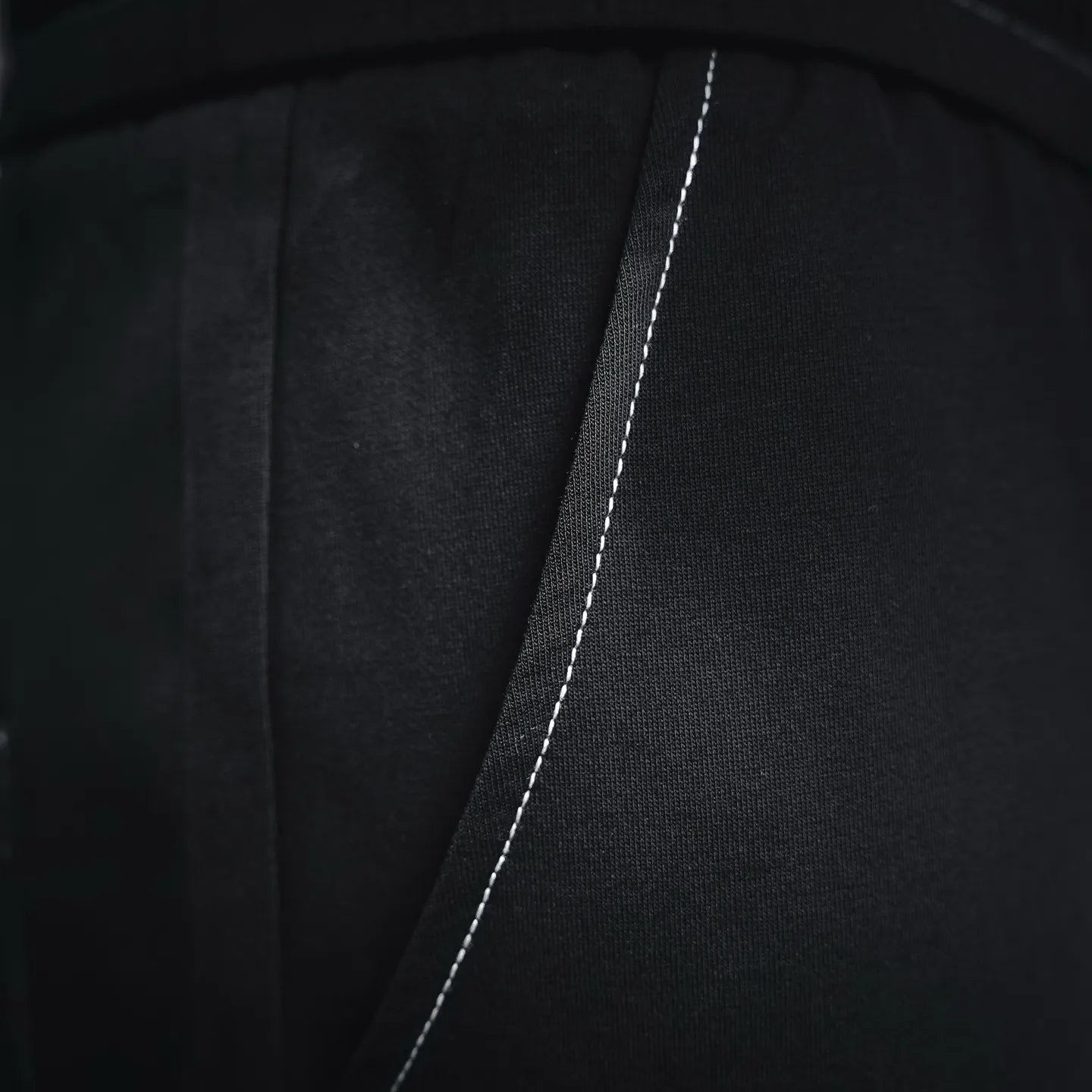 Prada black pants side seam close-up with contrasting stitch line