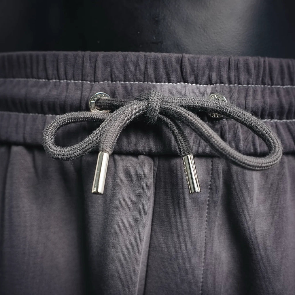 Dark gray drawstring with metal aglets and elastic waistband