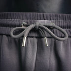 Dark gray drawstring with metal aglets and elastic waistband