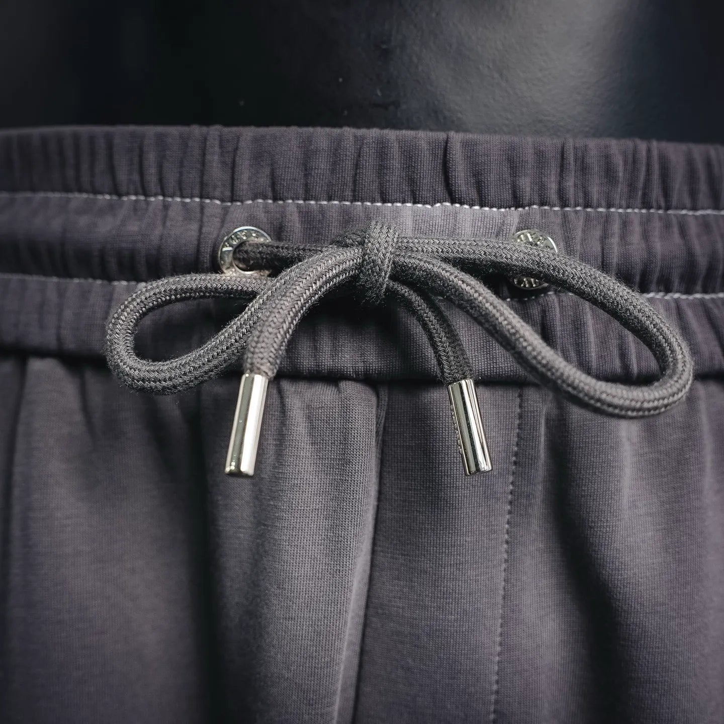 Dark gray drawstring with metal aglets and elastic waistband