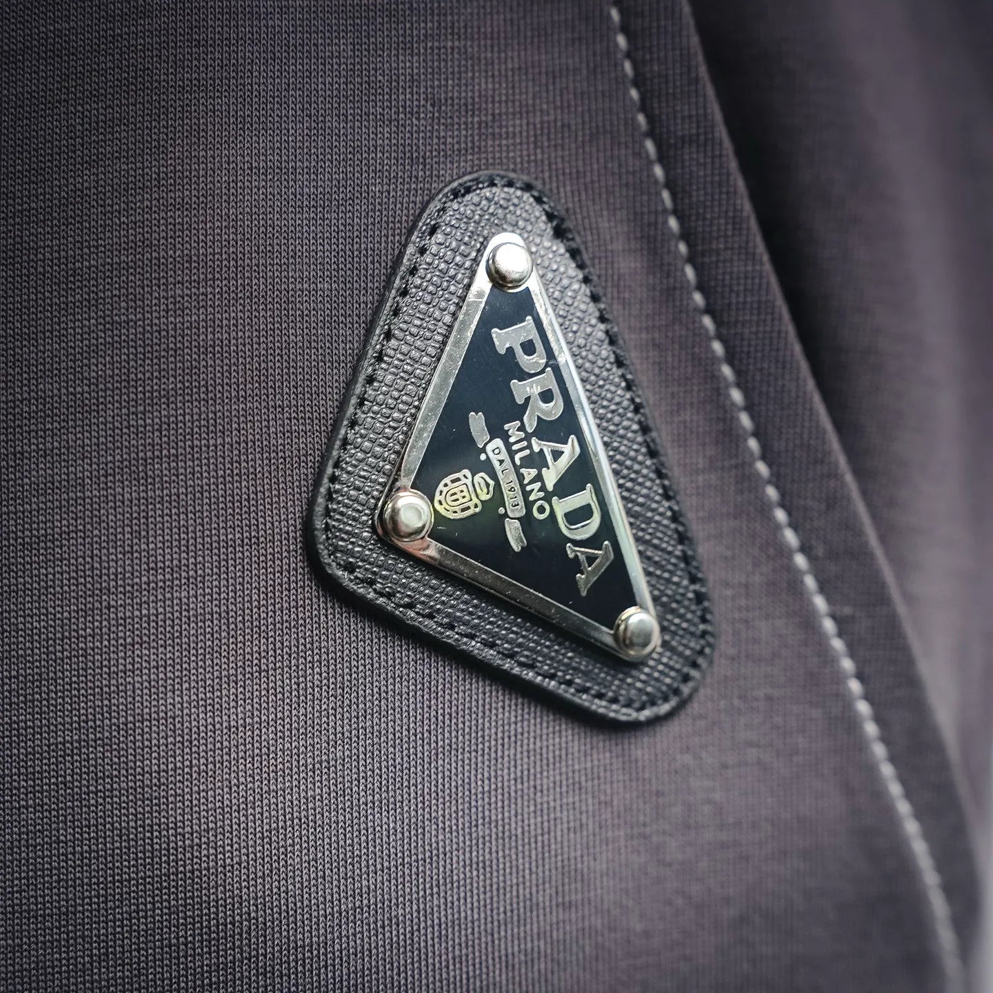 Dark gray pants with PRADA MILANO logo leather patch